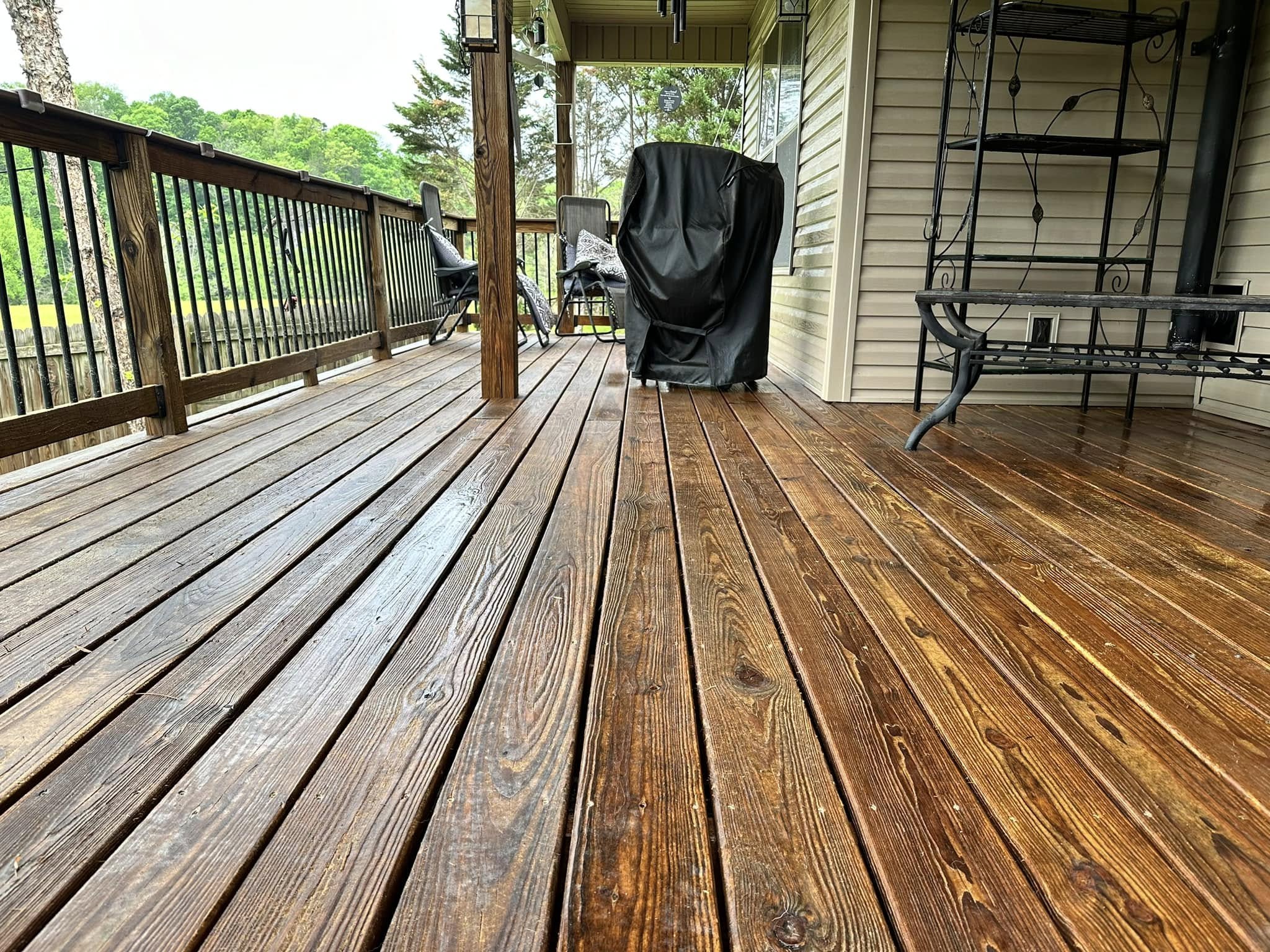 Restored dark-stained wooden deck with clean plank surfaces