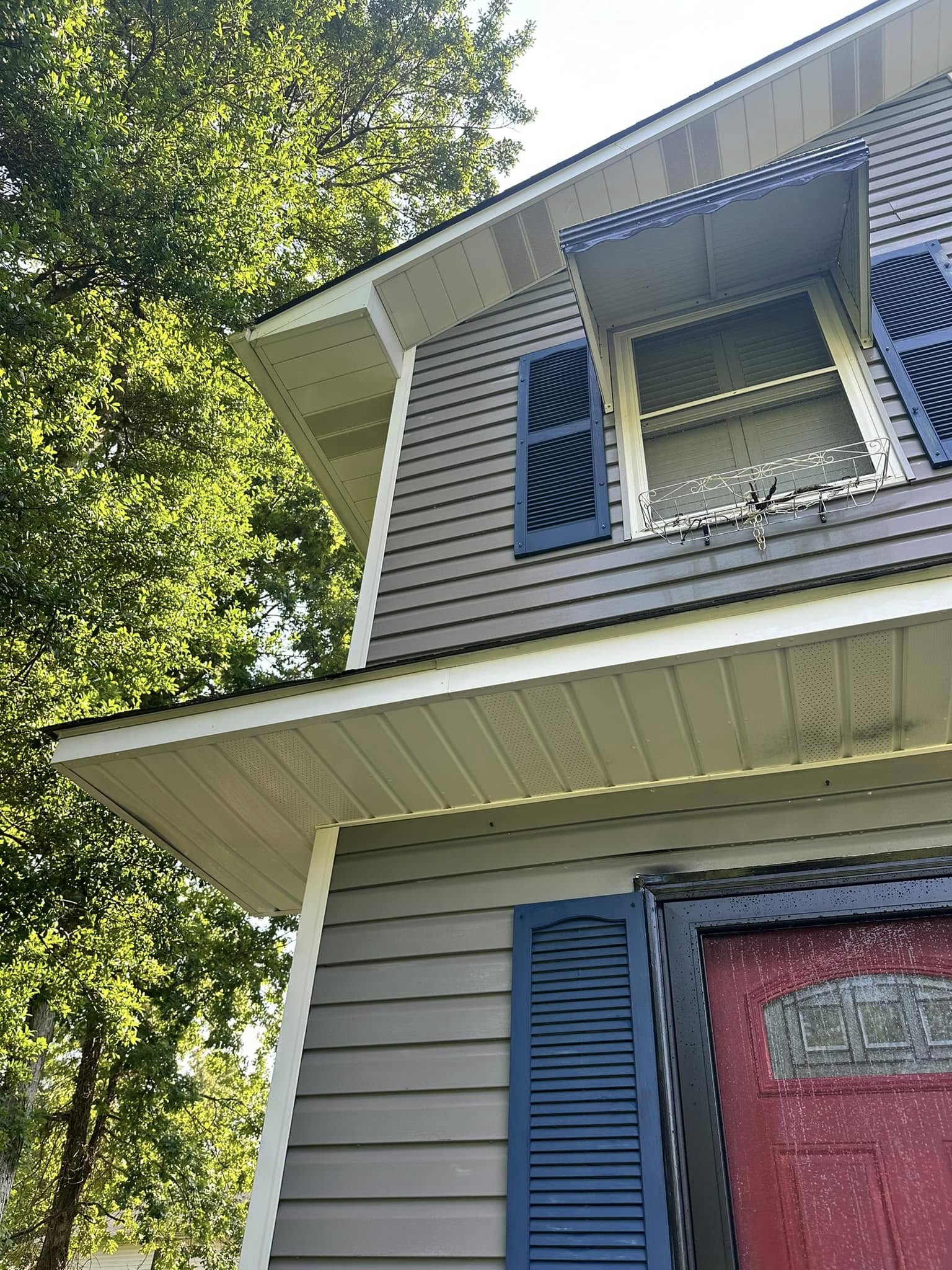 Two-story gray vinyl home showing exterior surfaces ready for professional house washing